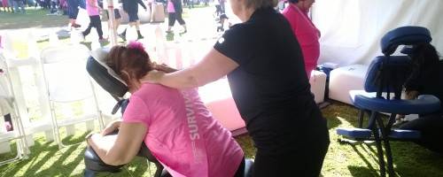 Joannie giving chair massage to breat cancel Survivor